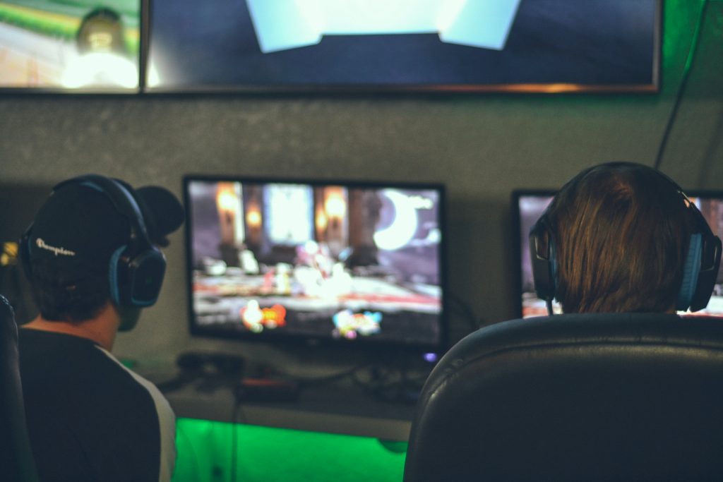 Gamers sitting in front of a computer and playing video games 