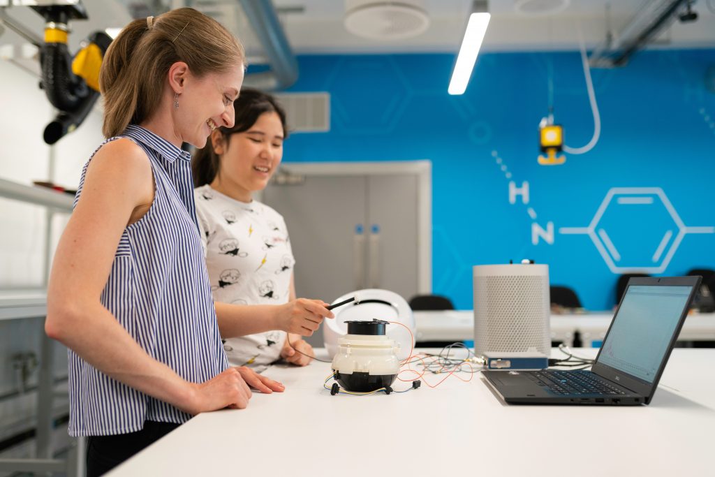 Two women testing a AI and ML model in a working station 