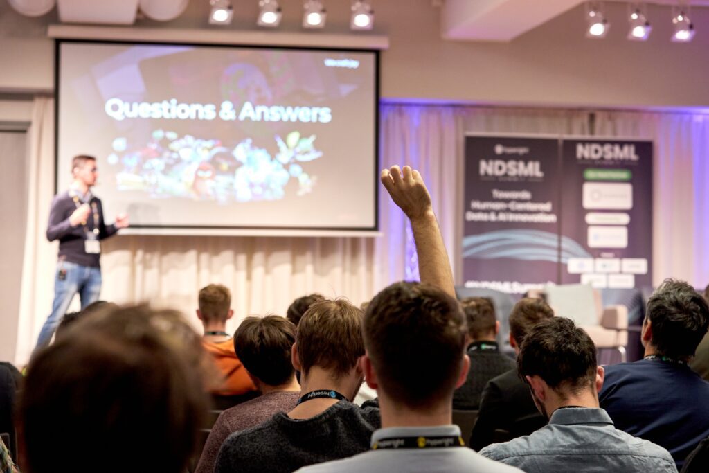 Attendee raising their hand during a Q&A at the 6th edition of the NDSML Summit